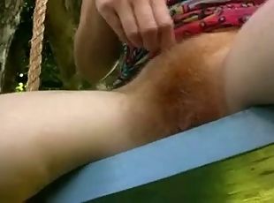 Young hairy pussy redhead walks nude in the garden