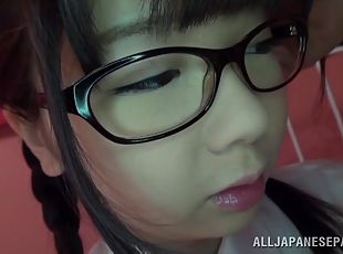 Japanese teen in glasses gives a titjob and rides a cock in POV video